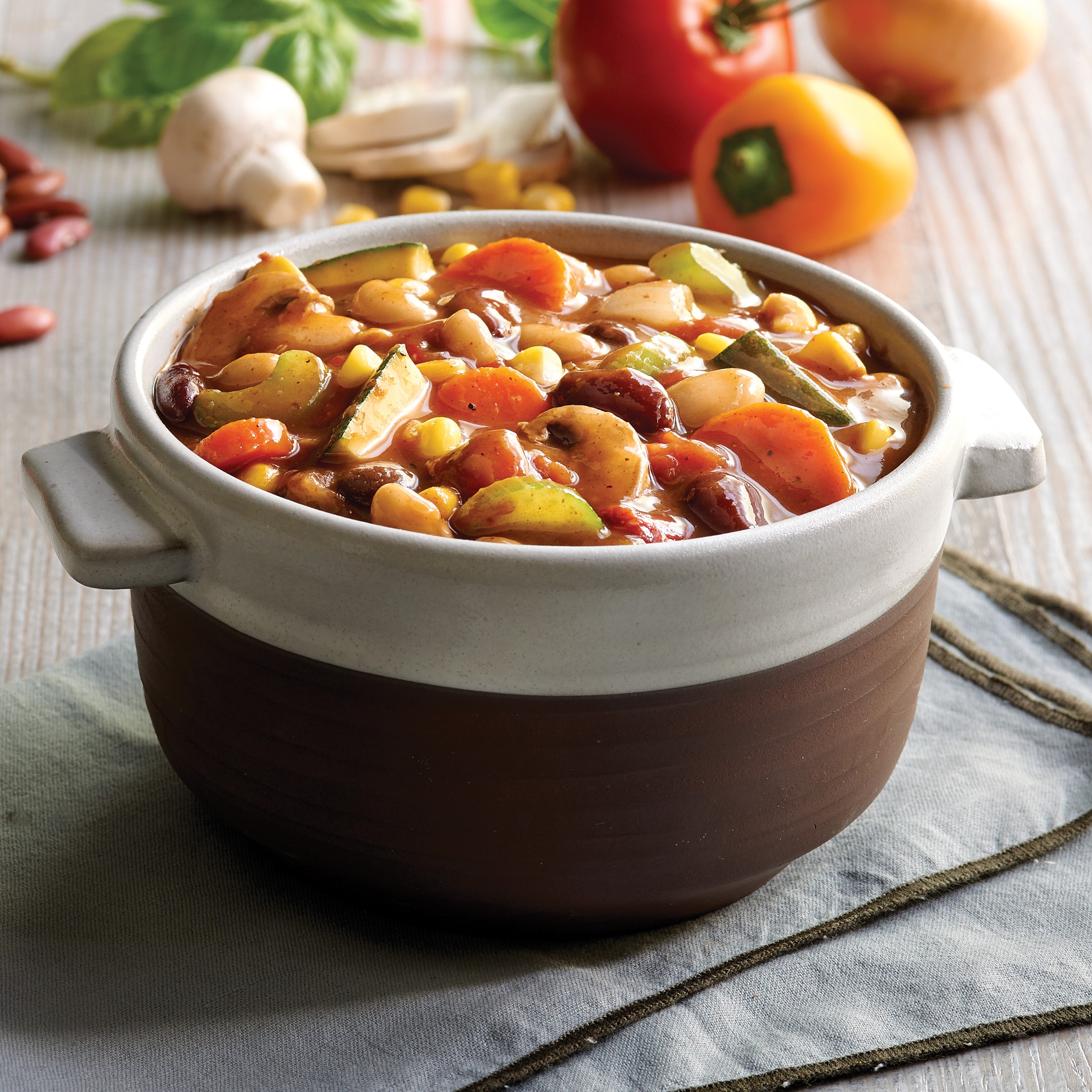 Bowl of foodservice Whitey's Frozen Chili Manufacturers Chipotle Garden Vegetable Chilii in a restaurant setting