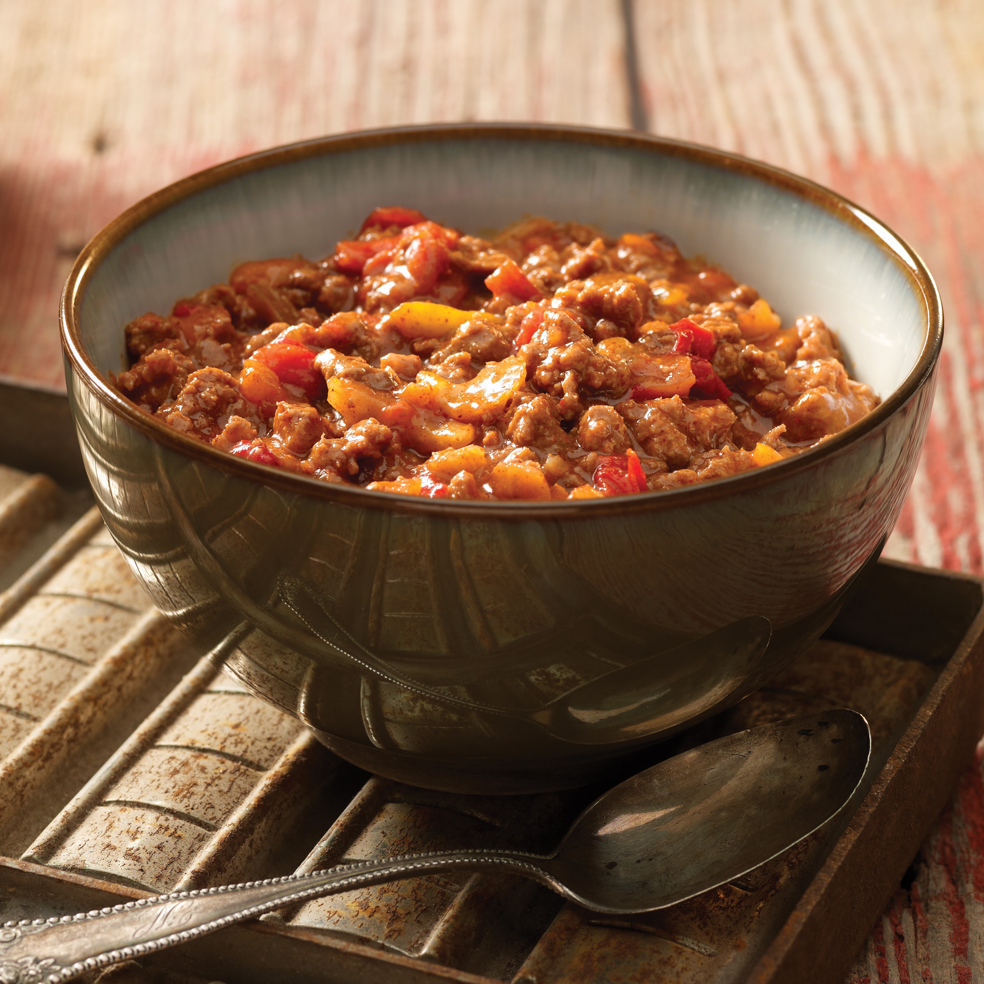 Bowl of foodservice Whitey's Frozen Chili Manufacturers Jalapeno Beef Chili in a restaurant setting